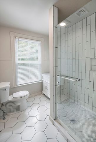 a bathroom with a toilet a sink and shower