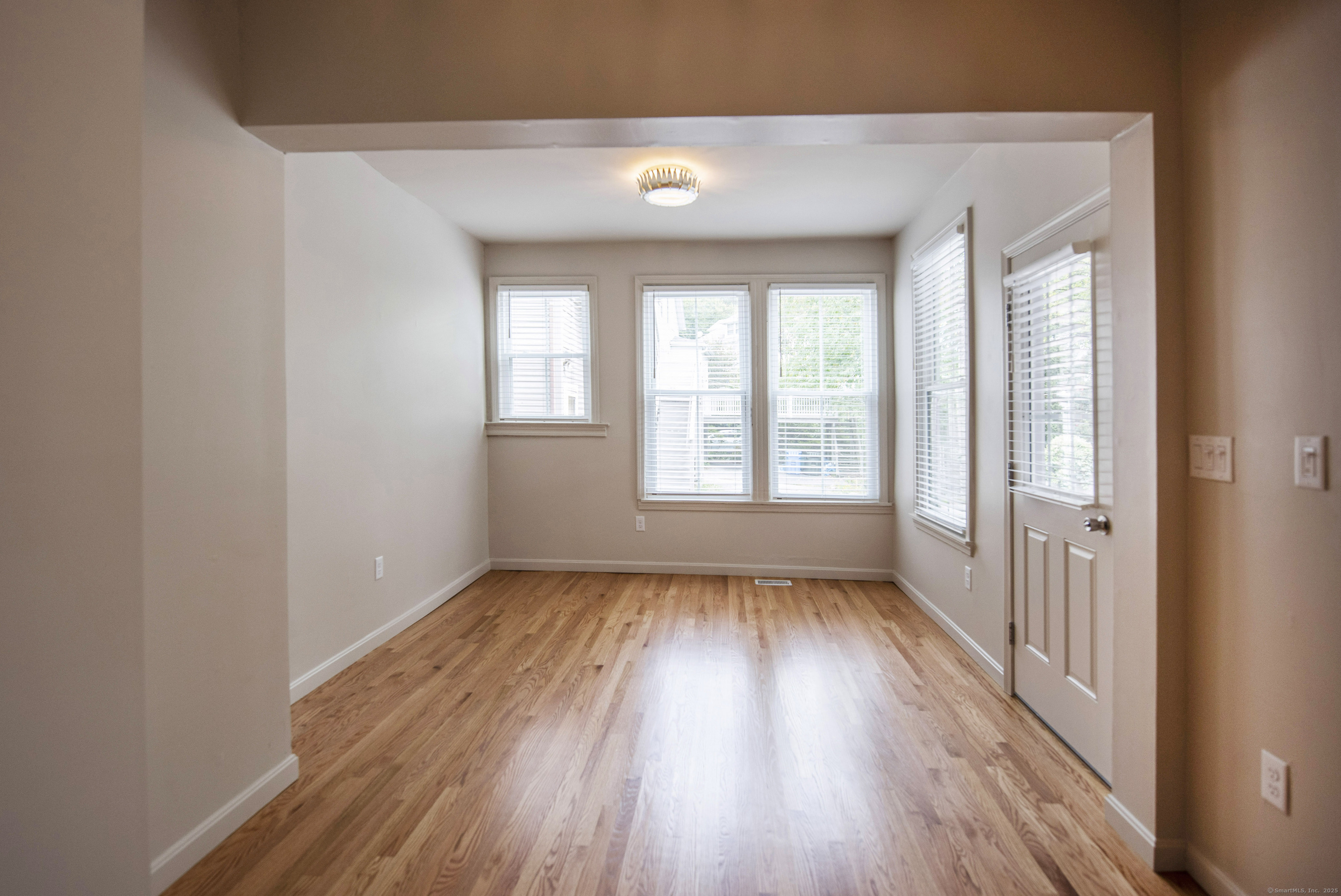 87 Broad Street Norwich, CT 06360 - Photo 27 of 29 wooden floor in an empty room with a window
