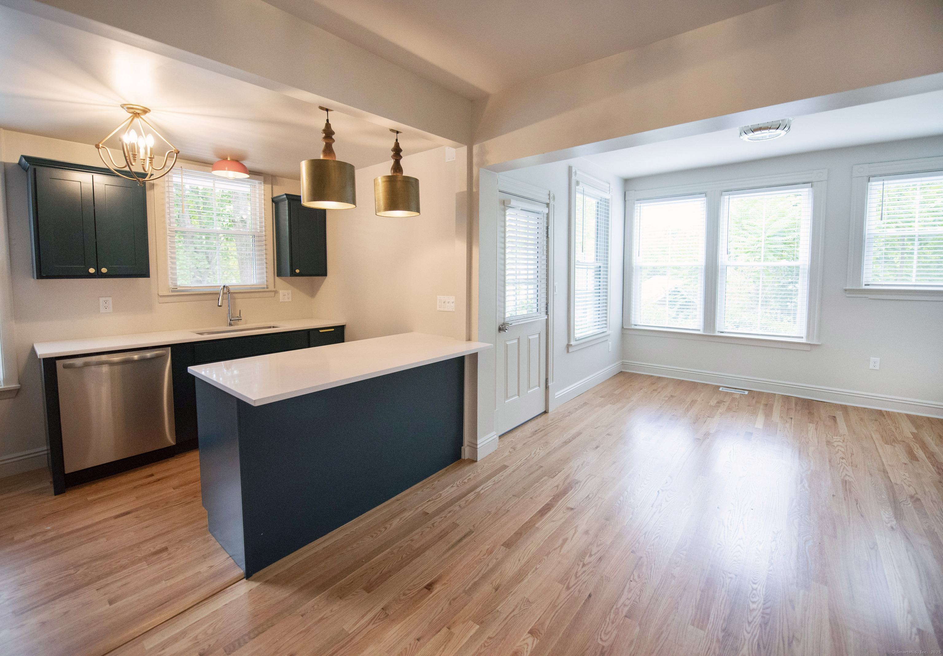 87 Broad Street Norwich, CT 06360 - Photo 4 of 29 a room with wooden floors and chair