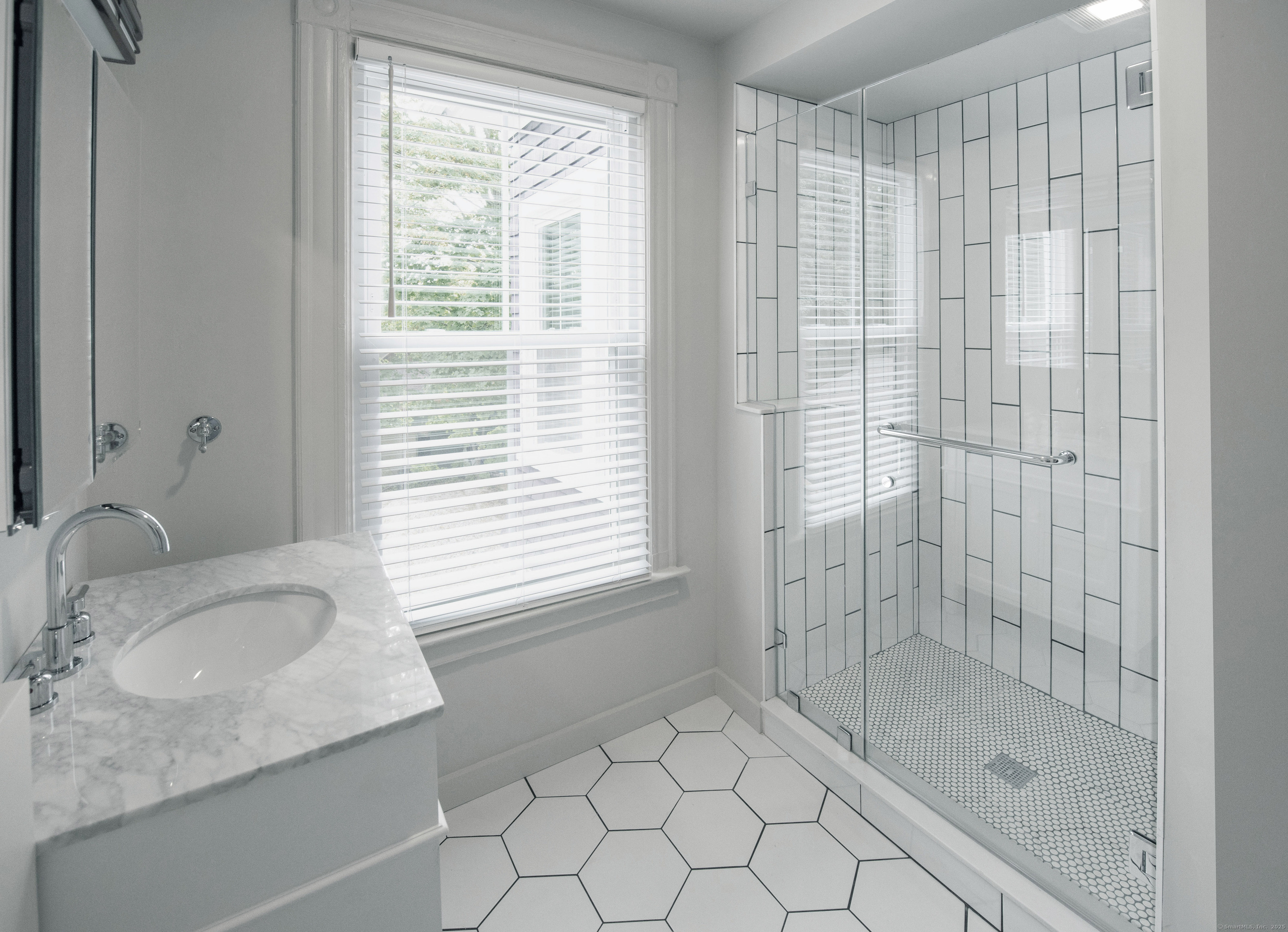 87 Broad Street Norwich, CT 06360 - Photo 5 of 29 a bathroom with a granite countertop sink a shower and a window