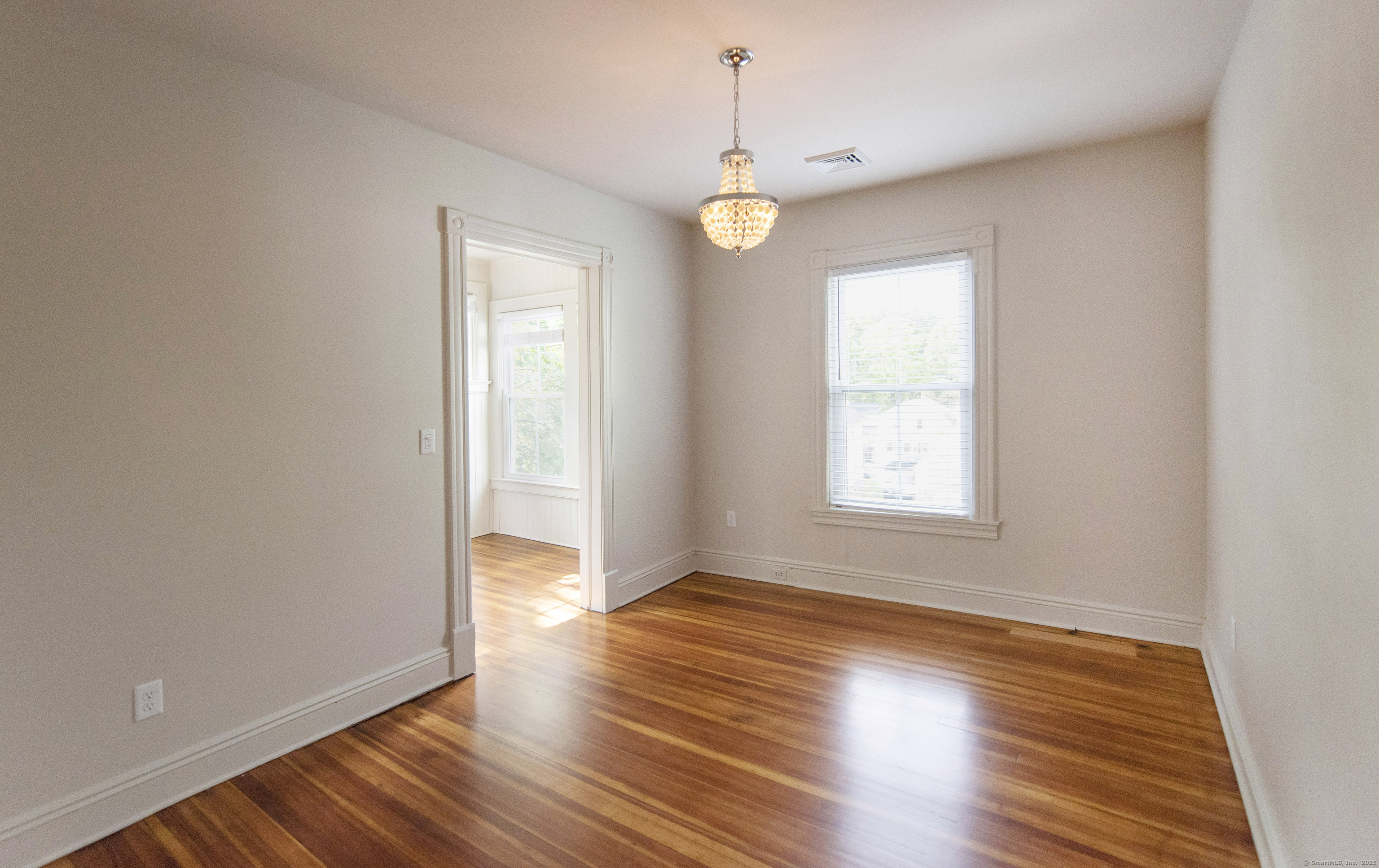 87 Broad Street Norwich, CT 06360 - Photo 8 of 29 an empty room with wooden floor and windows
