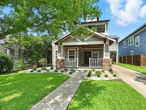 a front view of a house with a yard table and chairs