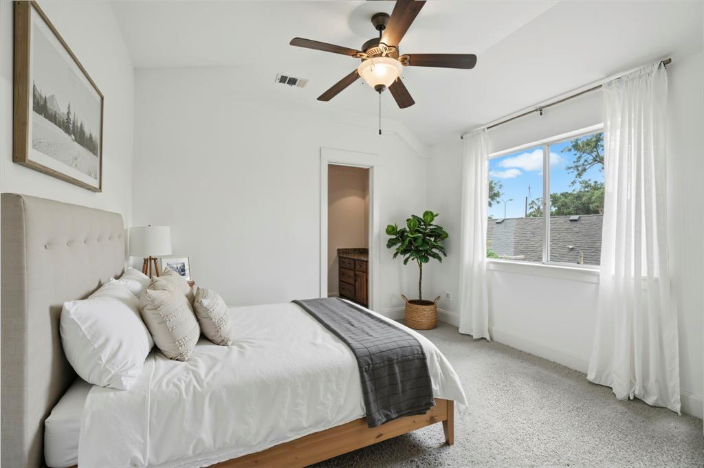 5535 Willis Avenue Dallas, TX 75206 - Photo 12 of 22 a bedroom with a large bed and a window