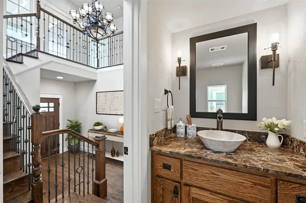 a spacious bathroom with a granite countertop sink a mirror and shower
