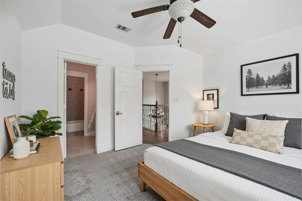 5535 Willis Avenue Dallas, TX 75206 - Photo 7 of 22 a bedroom with a large bed and a chandelier