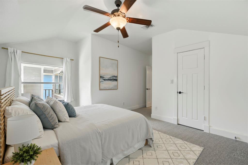 5535 Willis Avenue Dallas, TX 75206 - Photo 10 of 22 a bedroom with a bed and a chandelier