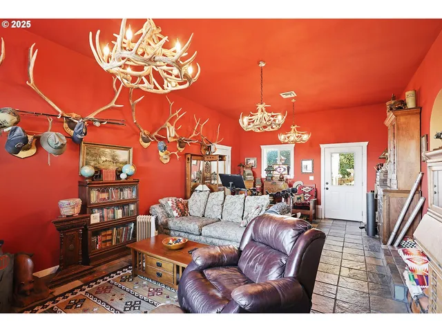 a living room with furniture a rug and a chandelier