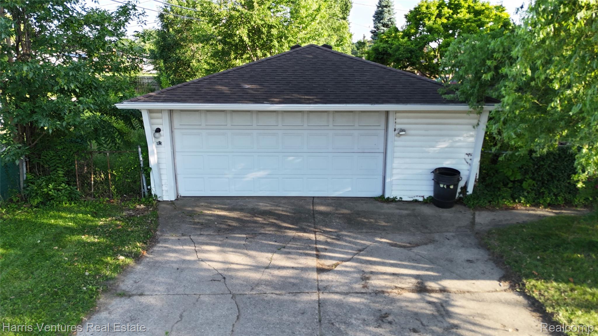 28482 Sutherland Avenue Warren, MI 48088 - Photo 24 of 25 Detached 2 car garage with a paneled overhead door and white horizontal siding