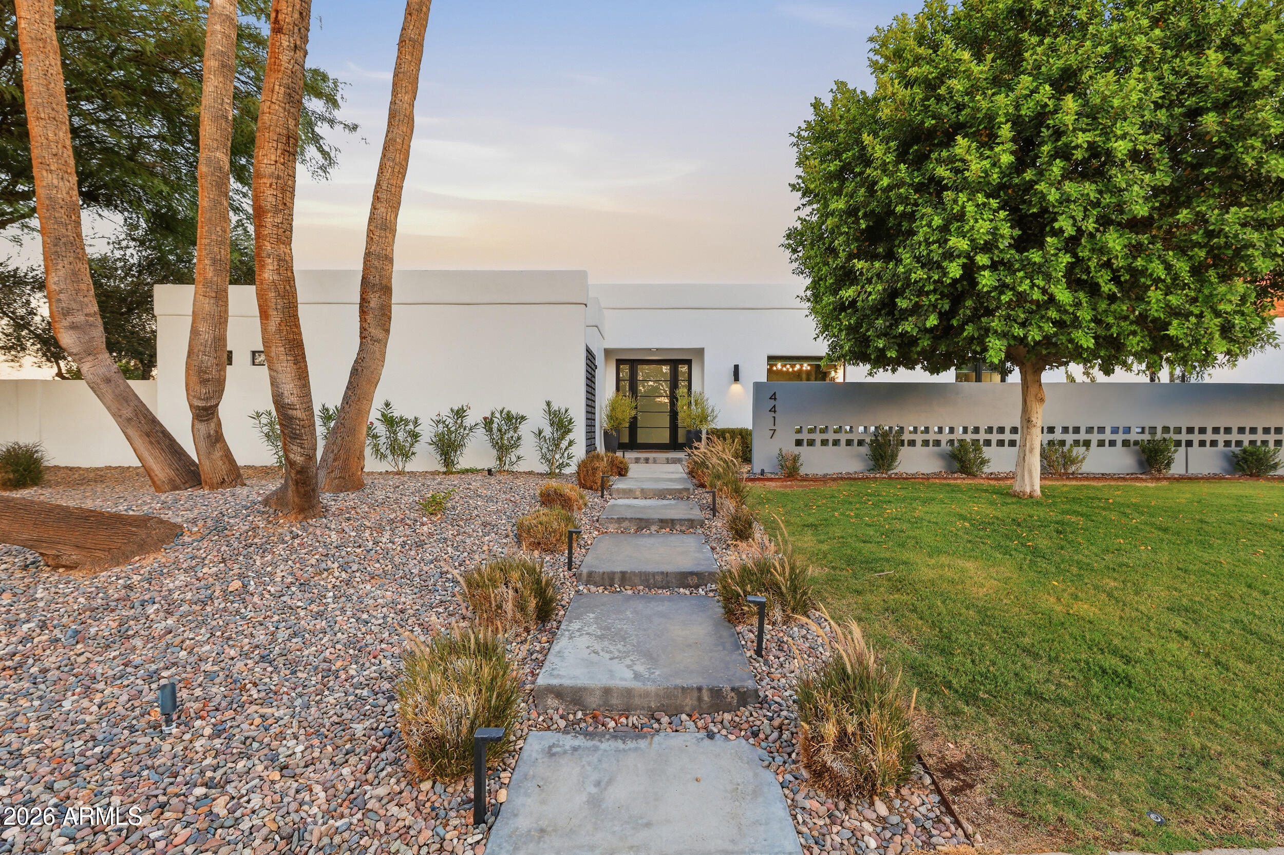 4417 East Mountain View Road Phoenix, AZ 85028 - Photo 1 of 41 a front view of a house with garden and patio