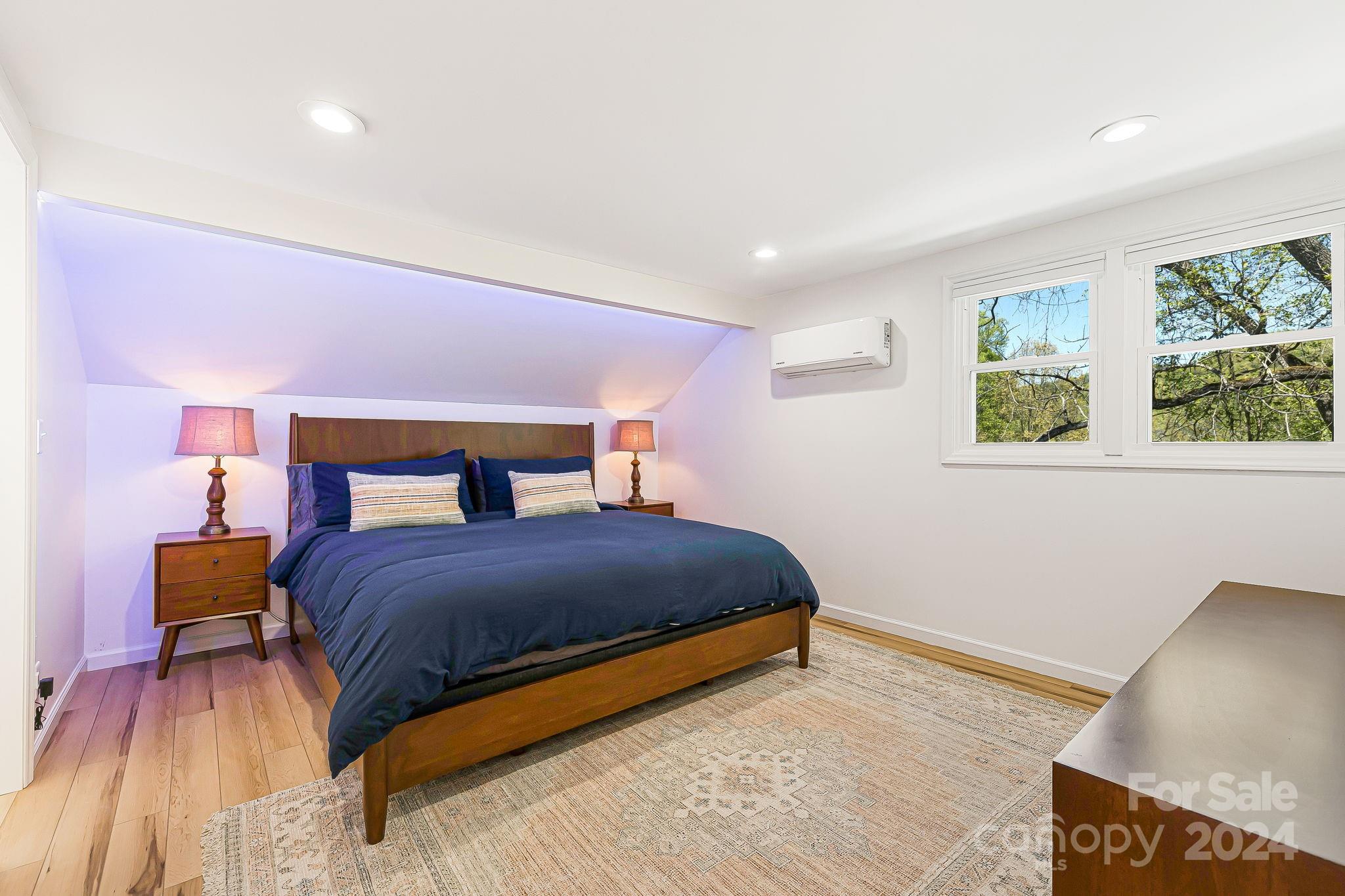 850 East Fork Road Marshall, NC 28753 - Photo 14 of 48 a bedroom with a bed and wooden floor