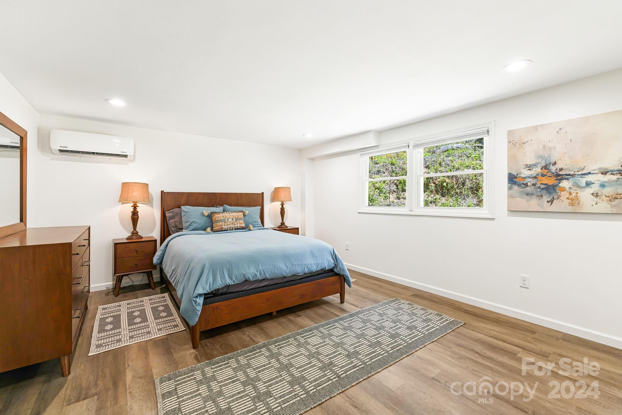 850 East Fork Road Marshall, NC 28753 - Photo 16 of 48 a bedroom with a bed rug and wooden floor