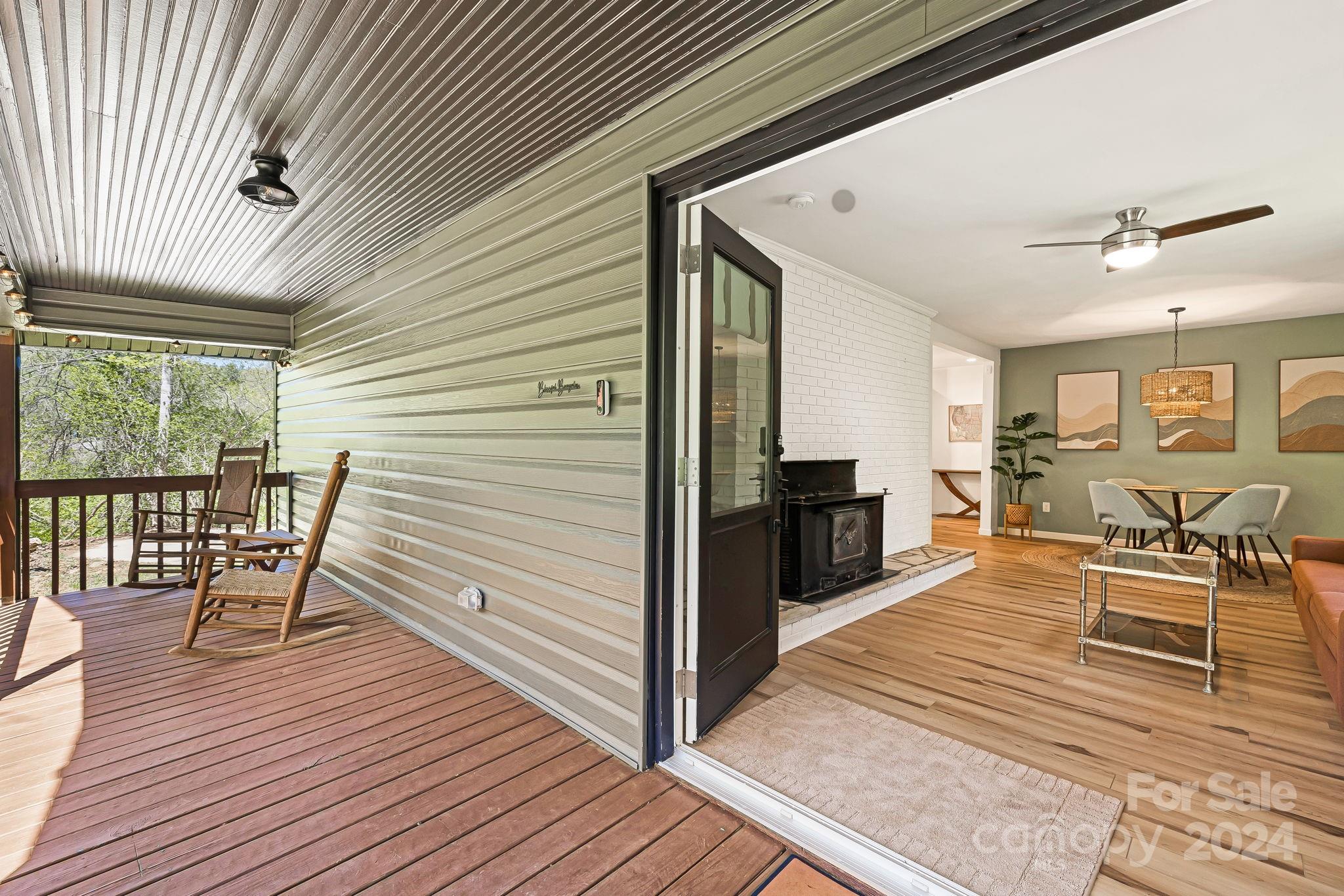 850 East Fork Road Marshall, NC 28753 - Photo 19 of 48 a view of a patio with table and chairs and wooden floor