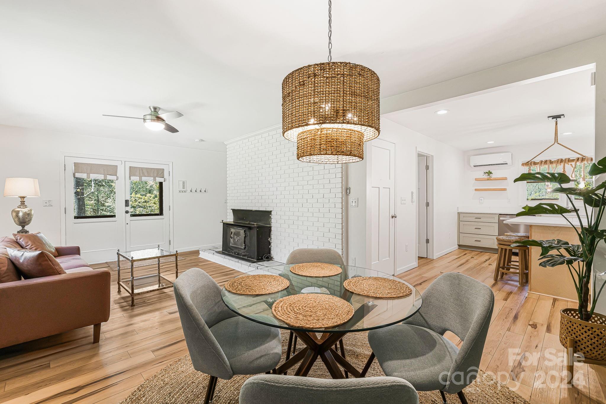 850 East Fork Road Marshall, NC 28753 - Photo 22 of 48 a view of a dining room with furniture a chandelier and wooden floor