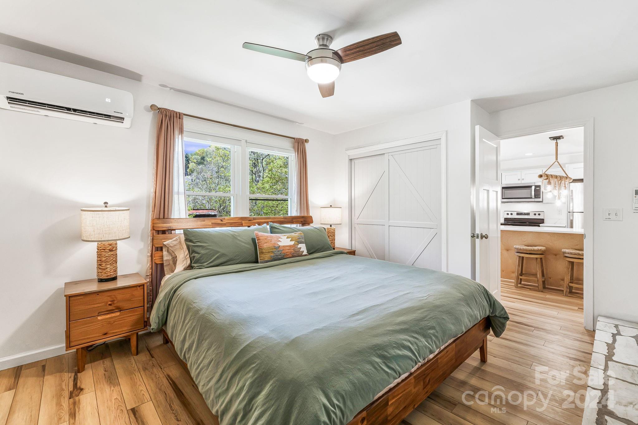 850 East Fork Road Marshall, NC 28753 - Photo 26 of 48 a bedroom with a bed and a view of kitchen