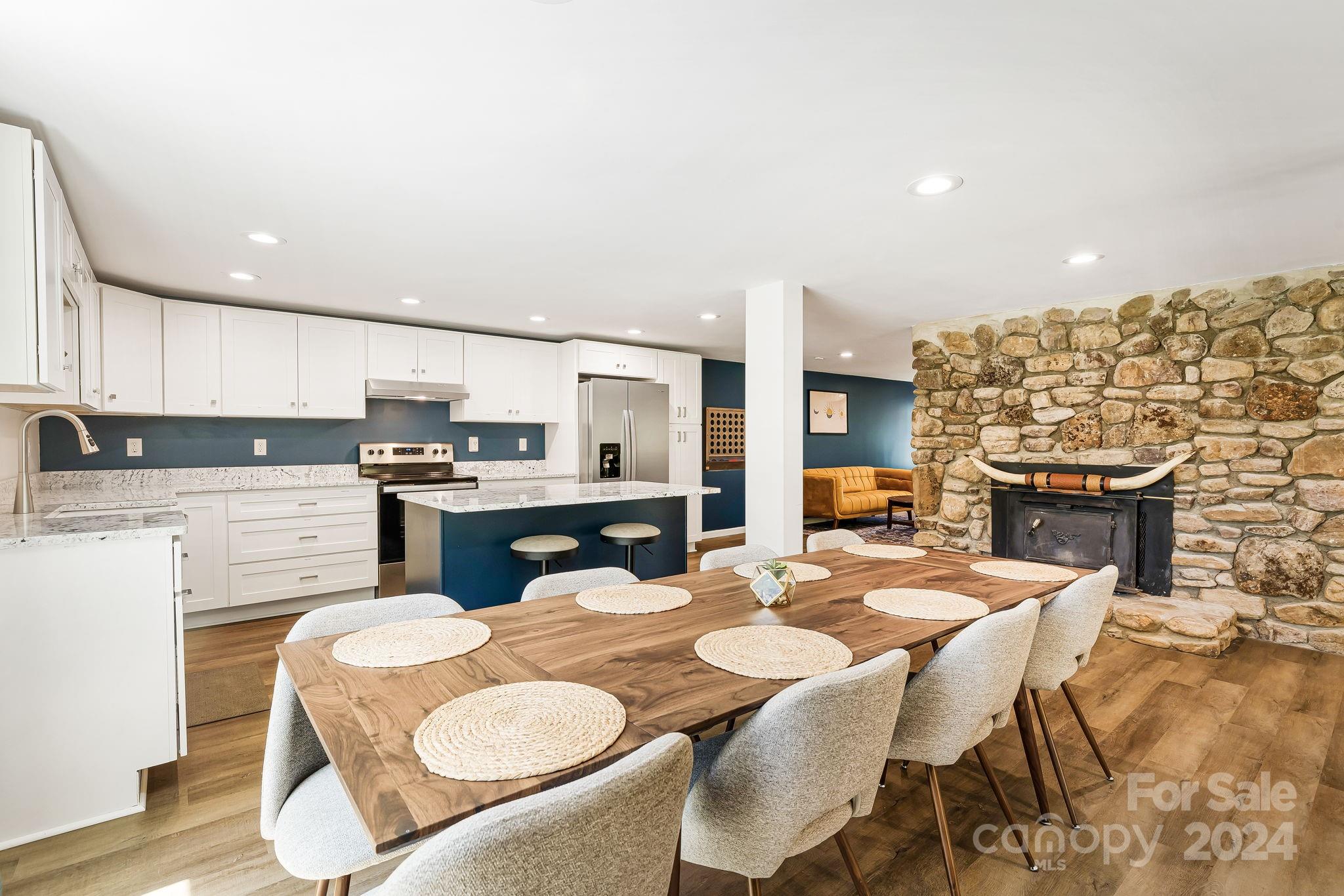 850 East Fork Road Marshall, NC 28753 - Photo 7 of 48 a open kitchen with stainless steel appliances kitchen island granite countertop a dining table and chairs