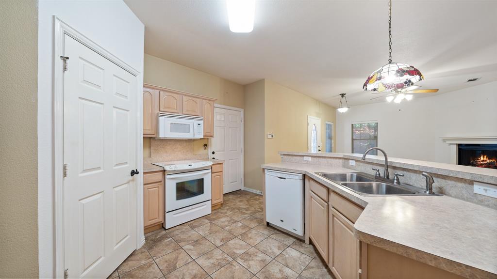 111 Sunglow Loop Red Oak, TX 75154 - Photo 12 of 25 a kitchen with a sink stove and refrigerator