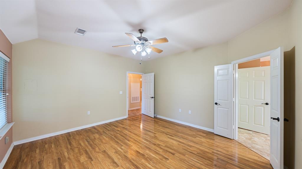 111 Sunglow Loop Red Oak, TX 75154 - Photo 14 of 25 a view of an empty room with chandelier fan and wooden floor