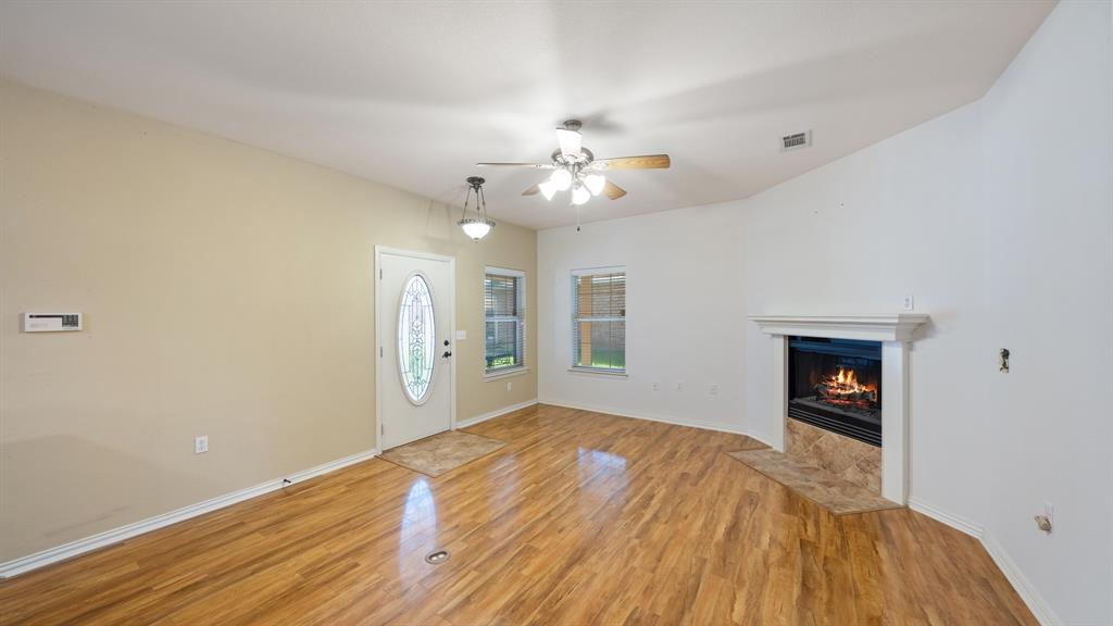 111 Sunglow Loop Red Oak, TX 75154 - Photo 7 of 25 a view of an empty room with window and chandelier fan