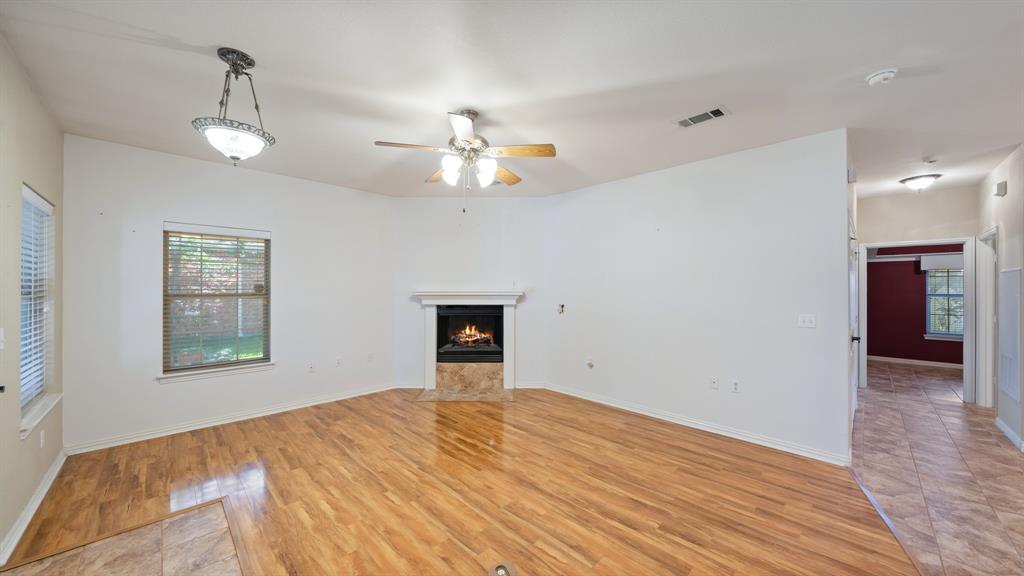 111 Sunglow Loop Red Oak, TX 75154 - Photo 8 of 25 wooden floor in an empty room with a window