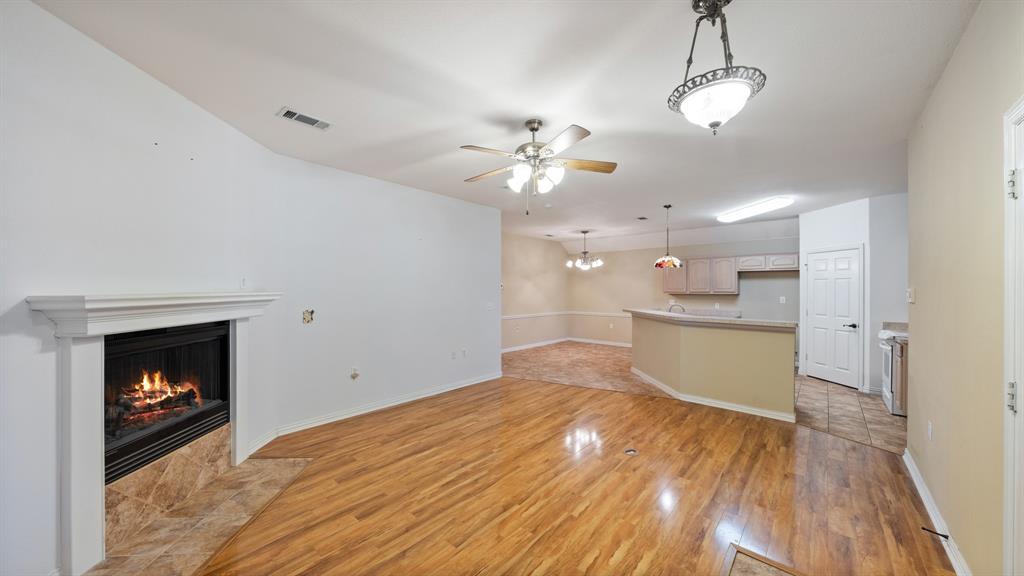 111 Sunglow Loop Red Oak, TX 75154 - Photo 9 of 25 a view of kitchen and empty room with wooden floor