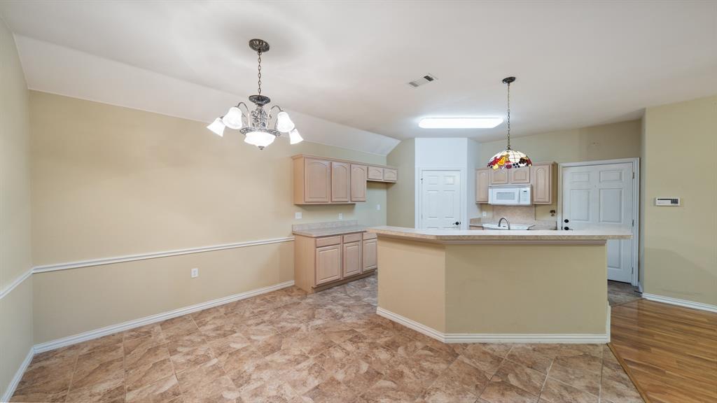 111 Sunglow Loop Red Oak, TX 75154 - Photo 10 of 25 a kitchen with a refrigerator and a sink