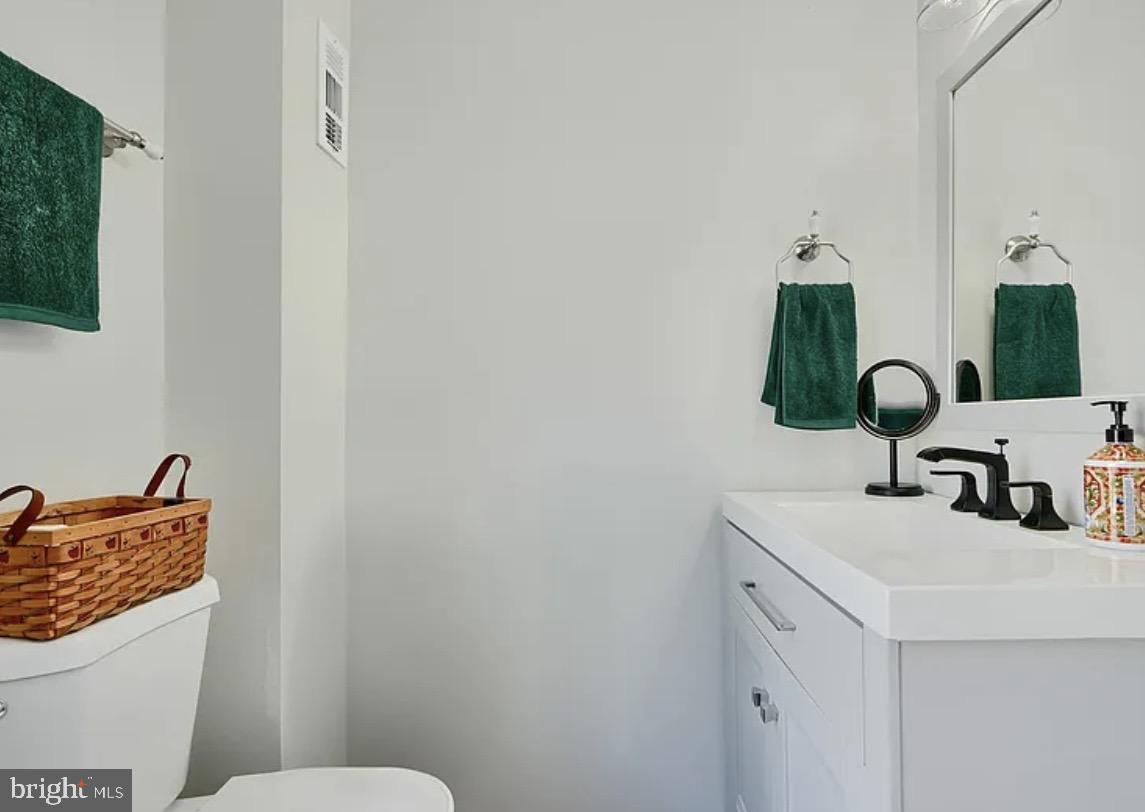 2242 East Fairmount Avenue Baltimore, MD 21231 - Photo 2 of 8 a bathroom with a sink and a toilet