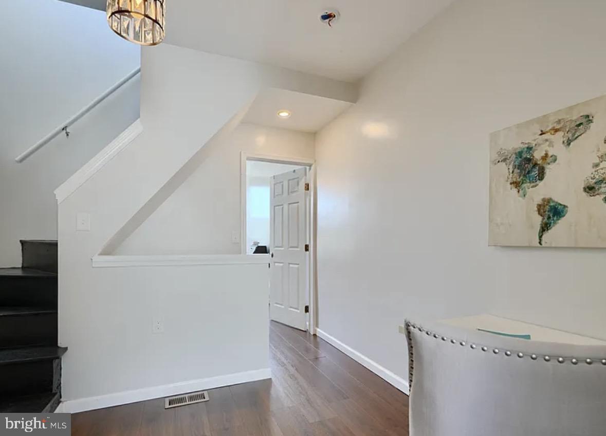 2242 East Fairmount Avenue Baltimore, MD 21231 - Photo 3 of 8 a view of a hallway with wooden floor and cabinet