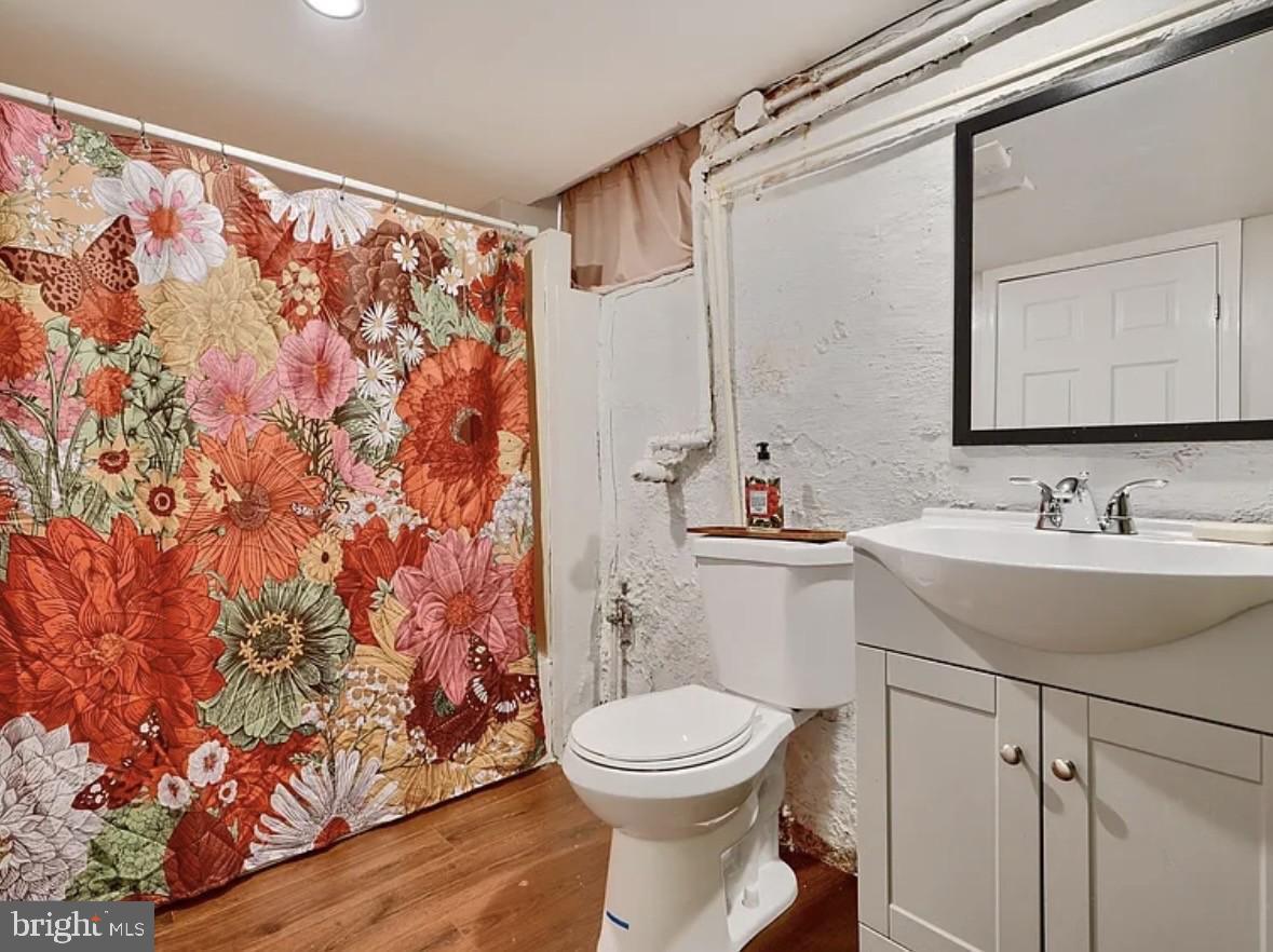 2242 East Fairmount Avenue Baltimore, MD 21231 - Photo 5 of 8 a bathroom with a sink toilet and shower