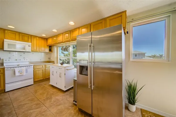 a kitchen with a refrigerator sink stove and cabinets