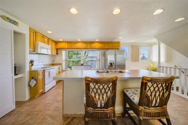 a dining room with furniture a large window and kitchen view