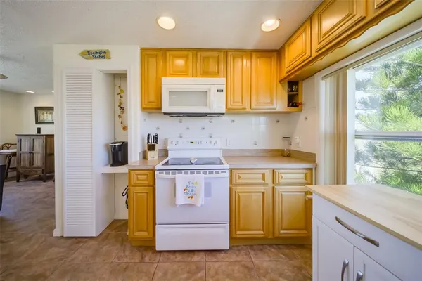 a view of kitchen with a sink appliances cabinets and a wooden floor