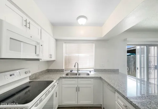a kitchen with a sink stove and cabinets