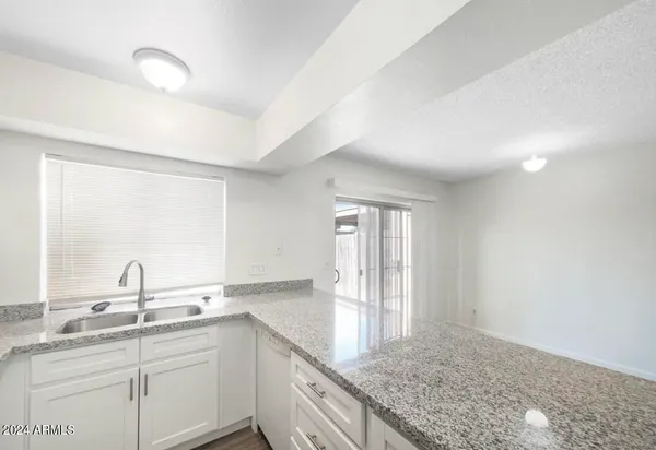 a kitchen with sink and cabinets