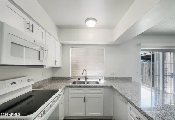 a kitchen with a sink stove and cabinets