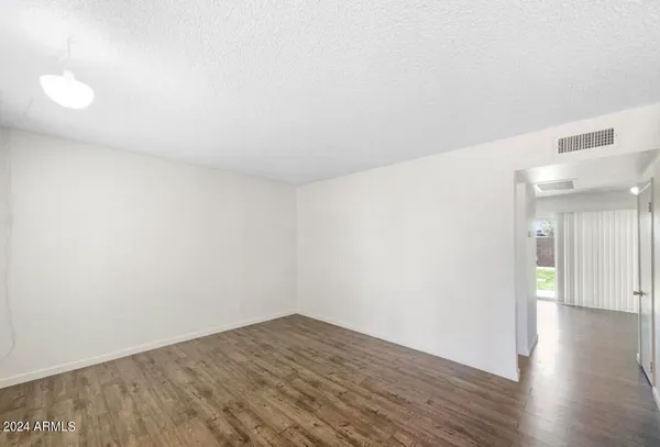 a view of a room with wooden floor