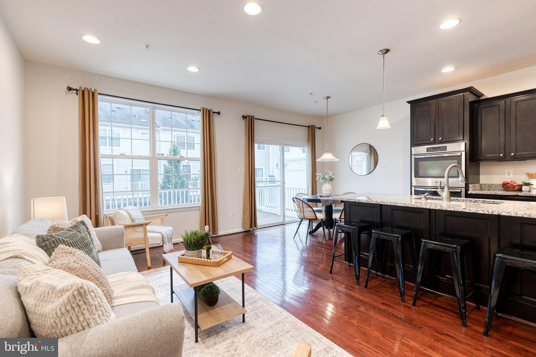 7951 Silver Oak Road Hanover, MD 21076 - Photo 13 of 41 a living room with lots of furniture and kitchen view