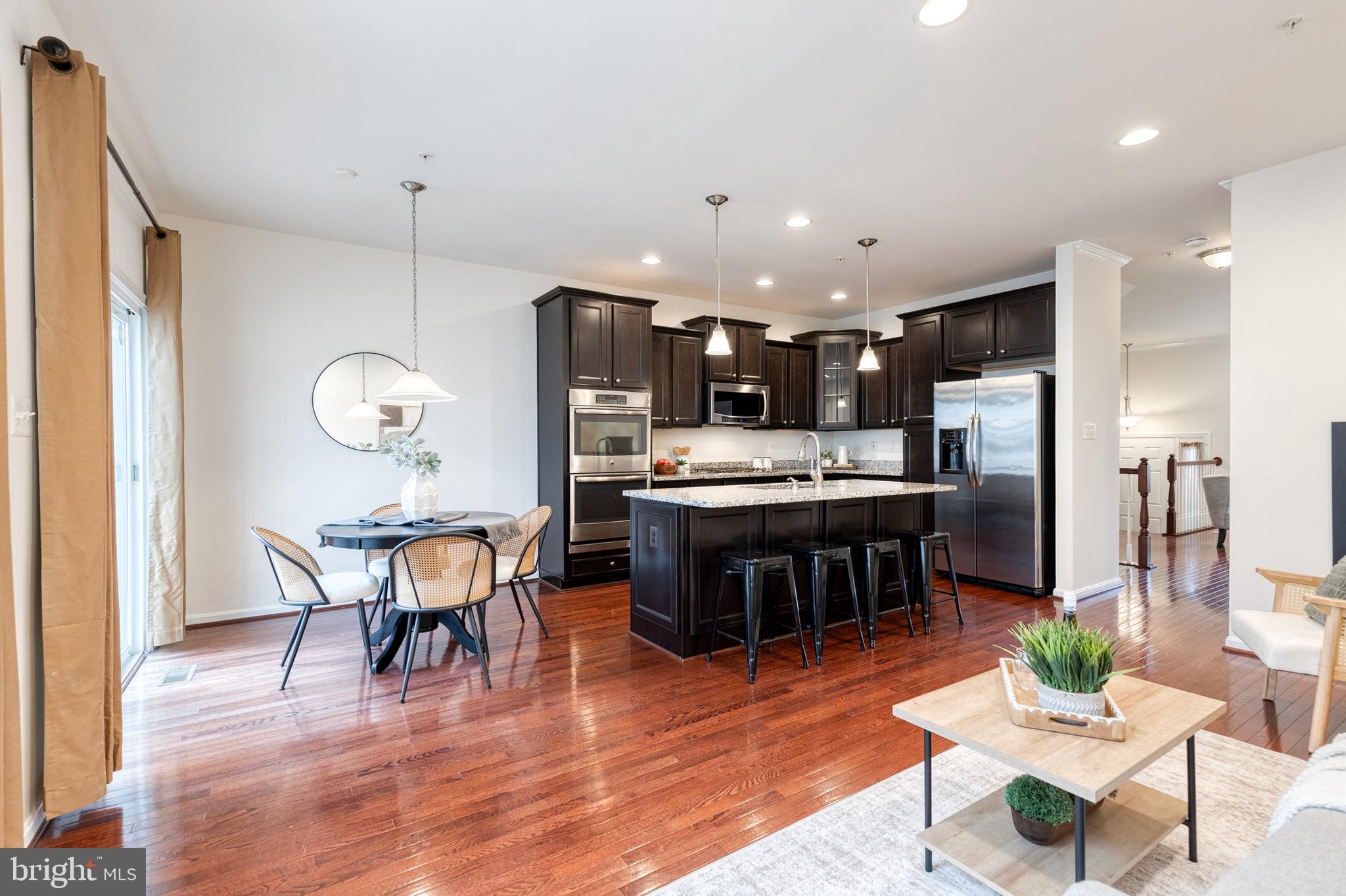 7951 Silver Oak Road Hanover, MD 21076 - Photo 15 of 41 a kitchen with a table and chairs in it