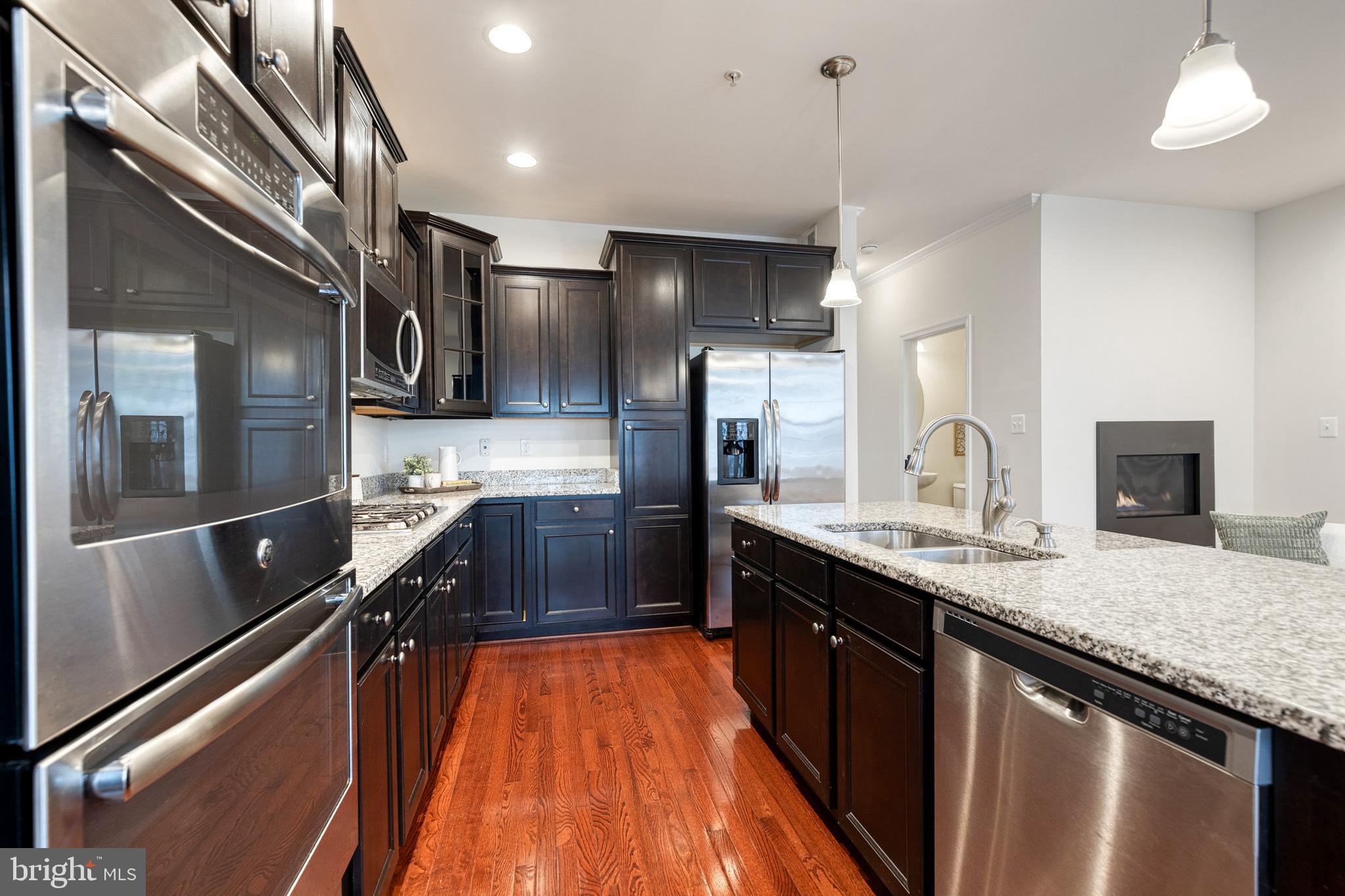 7951 Silver Oak Road Hanover, MD 21076 - Photo 21 of 41 a kitchen with stainless steel appliances granite countertop a sink a stove and a refrigerator