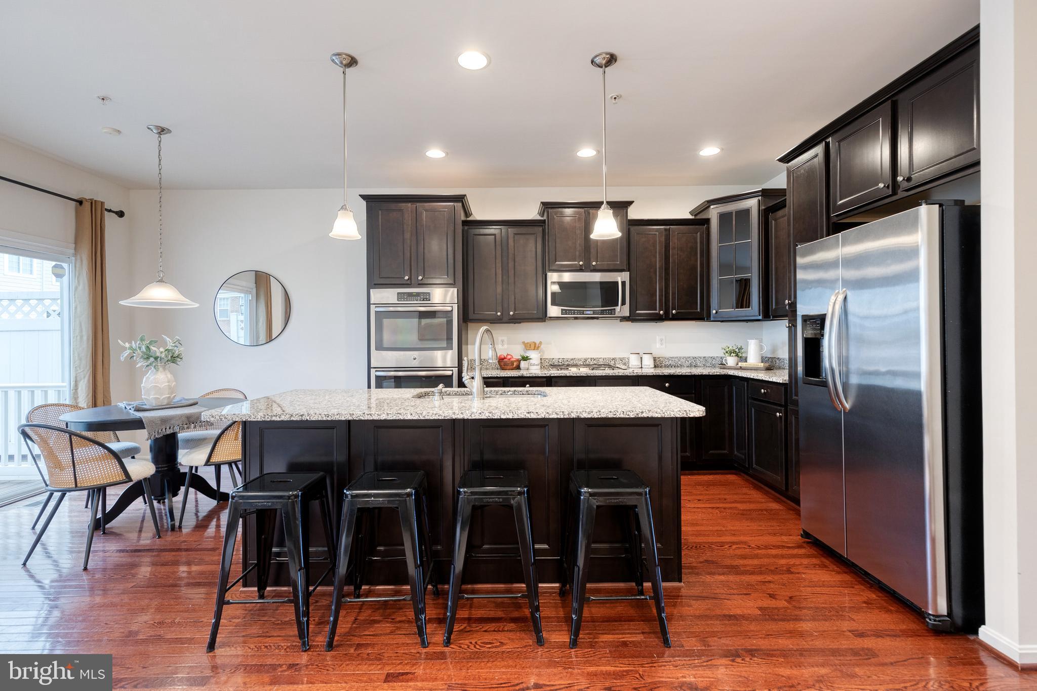 7951 Silver Oak Road Hanover, MD 21076 - Photo 22 of 41 a large kitchen with a table and chairs