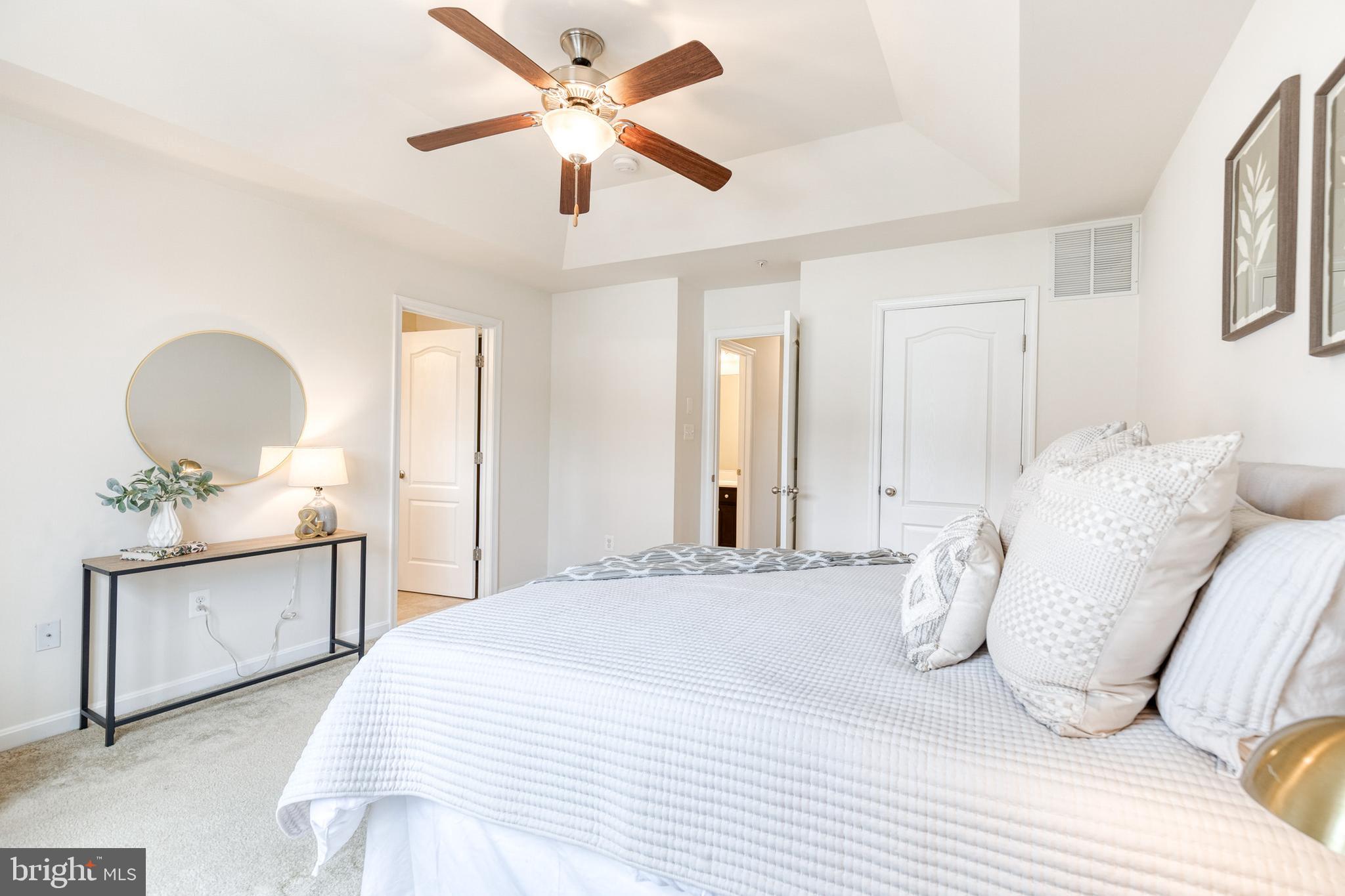 7951 Silver Oak Road Hanover, MD 21076 - Photo 27 of 41 a bedroom with a large bed and a chandelier