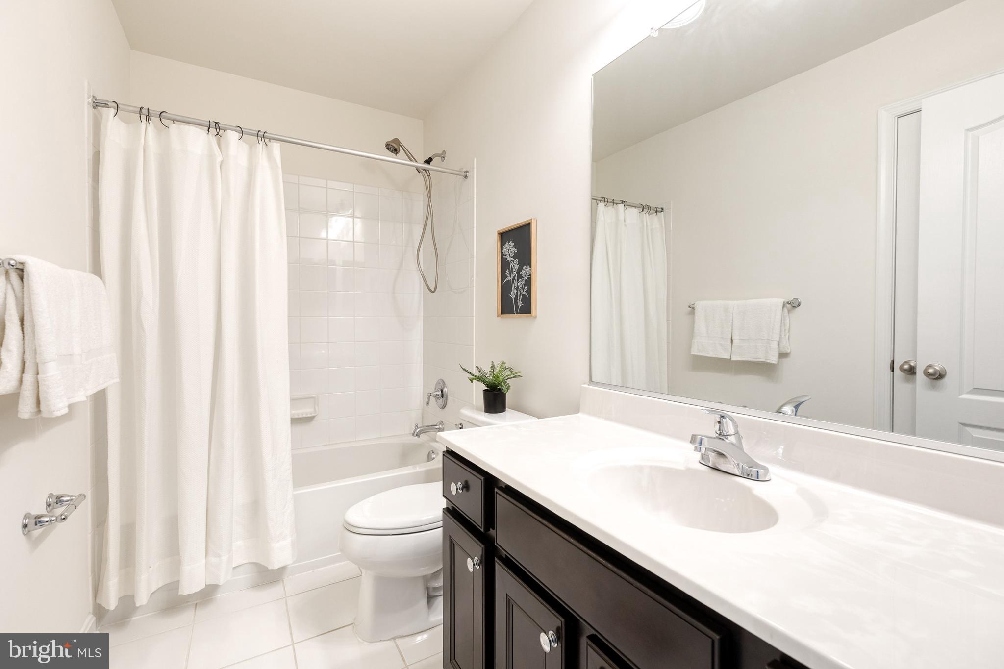 7951 Silver Oak Road Hanover, MD 21076 - Photo 31 of 41 a bathroom with a sink a toilet and shower curtain