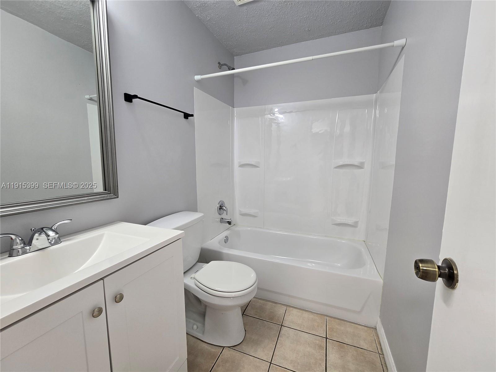 4548 Southeast Salvatori Road Stuart, FL 34997 - Photo 11 of 11 a bathroom with a bathtub shower sink vanity mirror and toilet