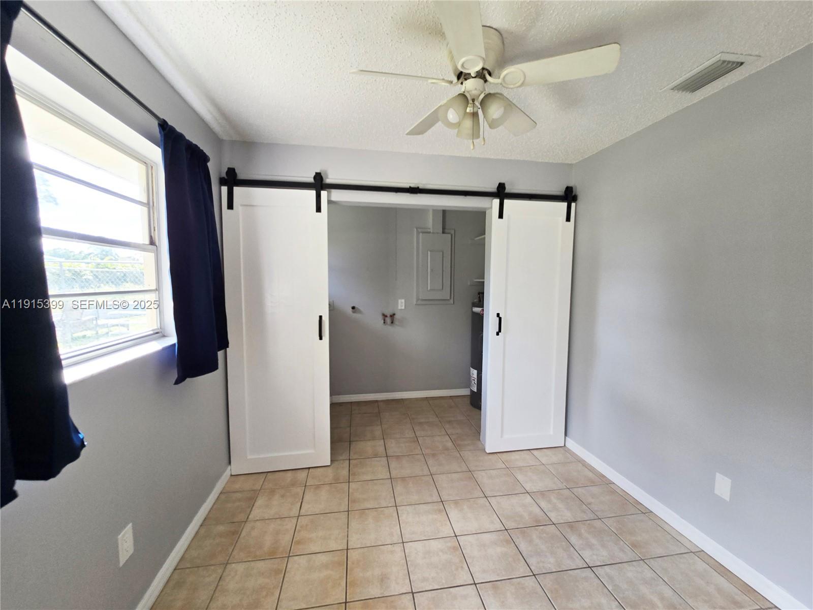 4548 Southeast Salvatori Road Stuart, FL 34997 - Photo 8 of 11 a view of an empty room with window and a kitchen
