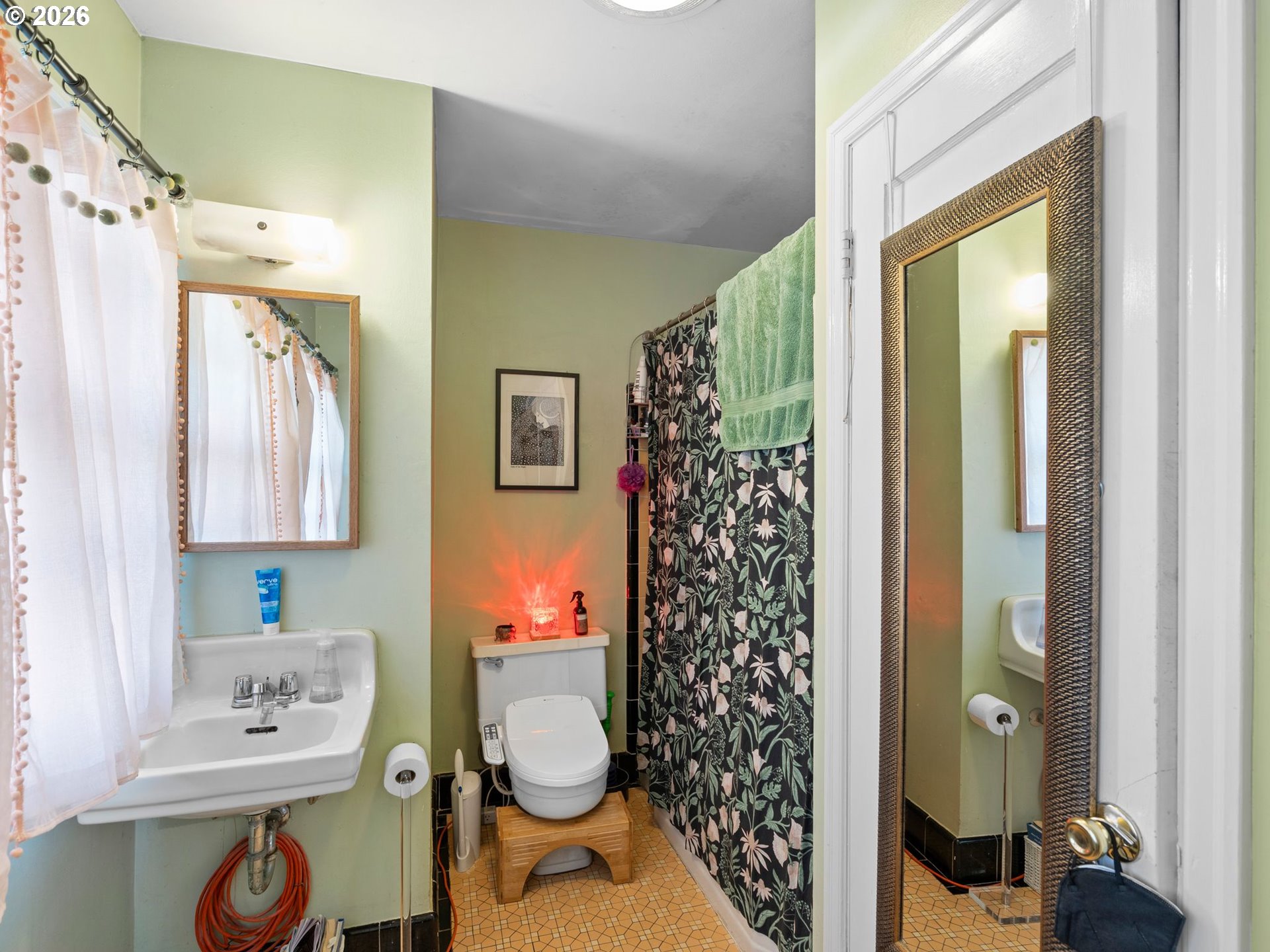 3306 Southeast 56th Avenue Portland, OR 97206 - Photo 25 of 36 a bathroom with a toilet sink and shower curtain