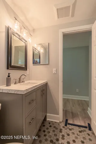 a bathroom with a sink a mirror and a shower