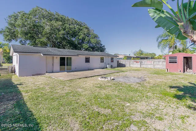 a backyard of a house with table and chairs