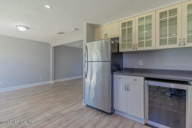 a kitchen with stainless steel appliances granite countertop a refrigerator and a stove top oven
