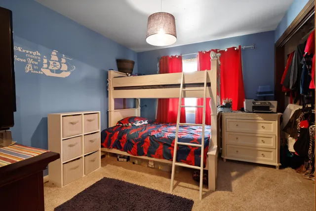 a bedroom with bed and window