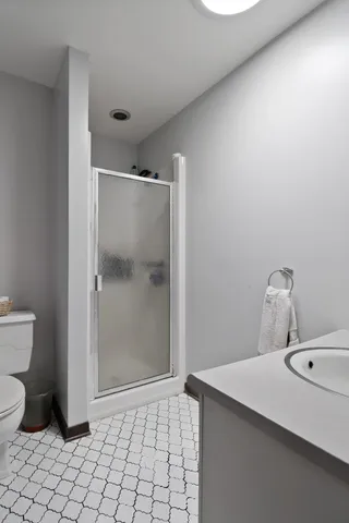 a room with a refrigerator and mirror