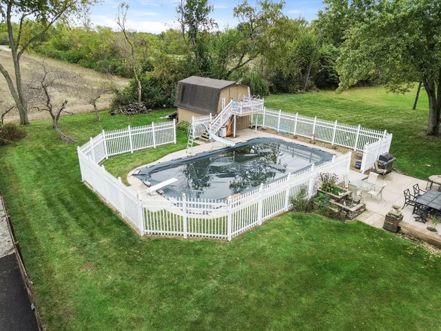 a living room with furniture a lamp and a potted plant